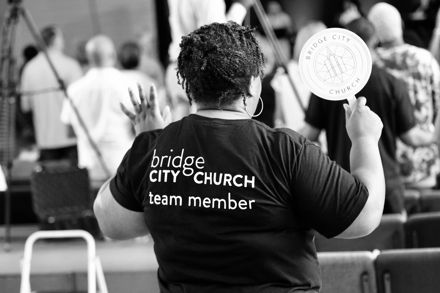 A Bridge City Church team member worshipping, photographed in black and white